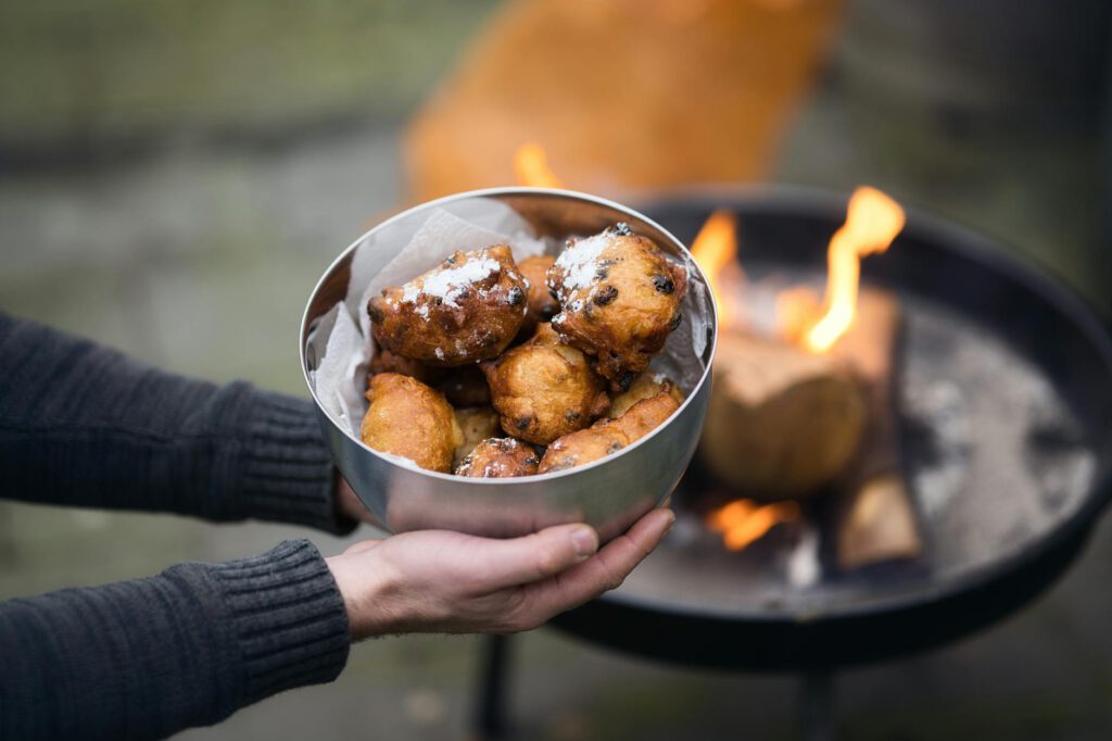 traditional dutch oliebollen by outdoor fire